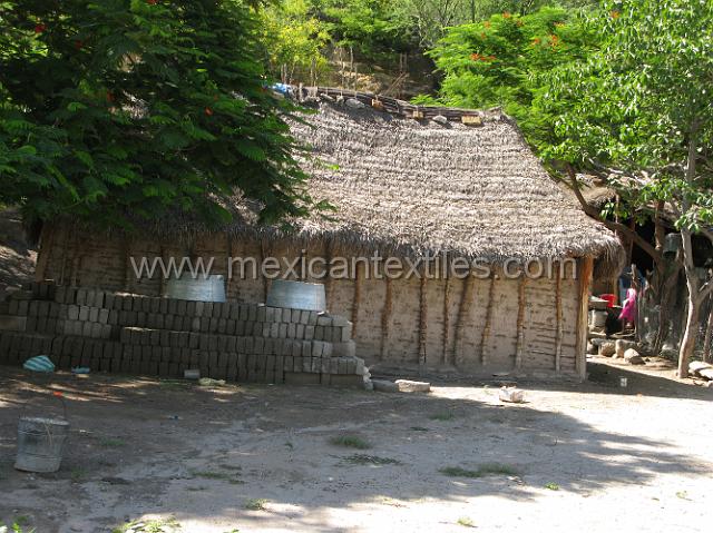 tecuiziapan_nahuatl19.JPG - Old style adobe home with a thatched roof.